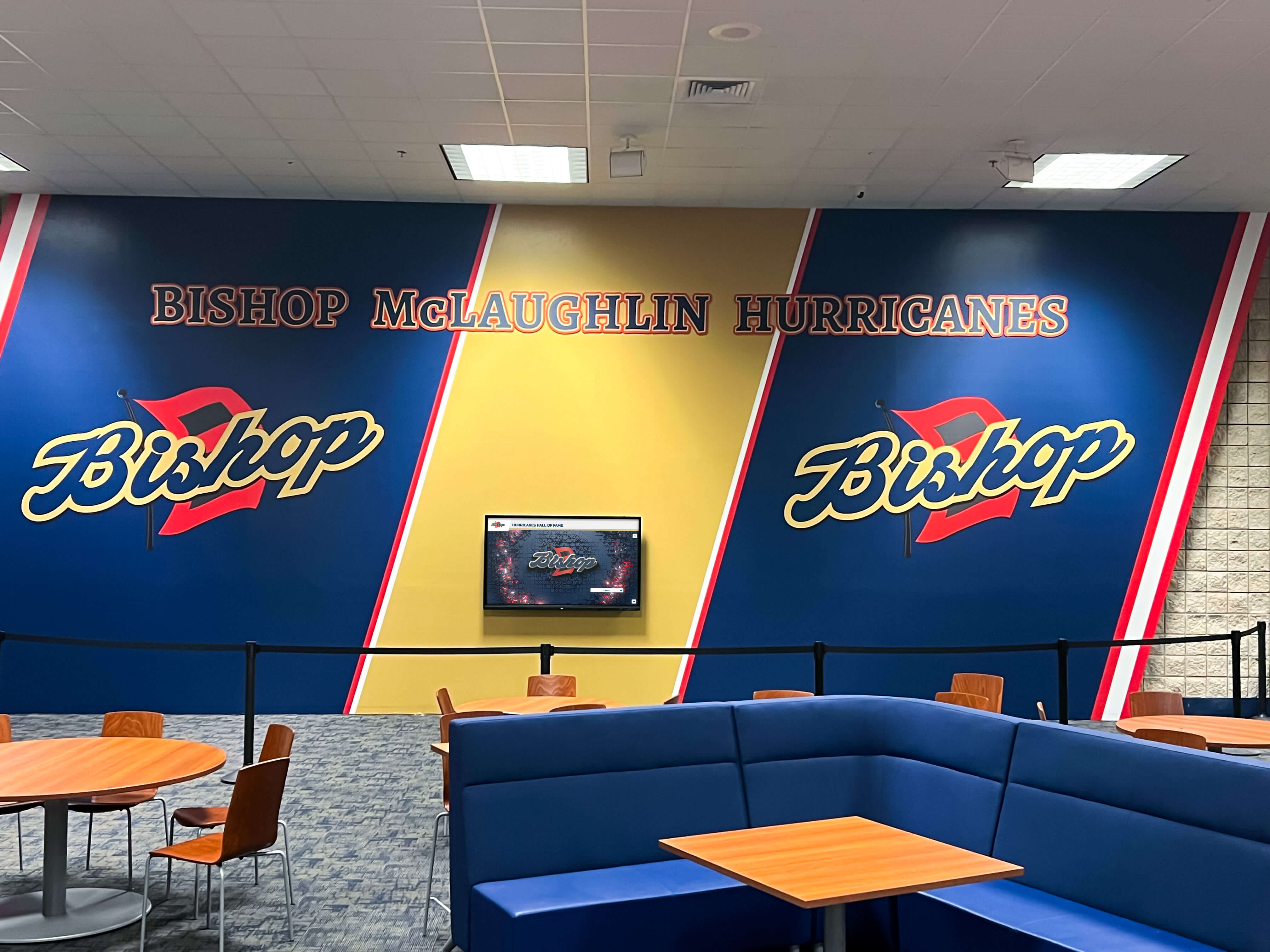 Bishop McLaughlin Hurricanes cafeteria lounge mural — the recognition traditions displayed throughout school facilities like this one depend on accurate award records maintained through seasonal database imports Bishop McLaughlin Hurricanes cafeteria lounge mural showing school recognition and spirit artwork in a school common area