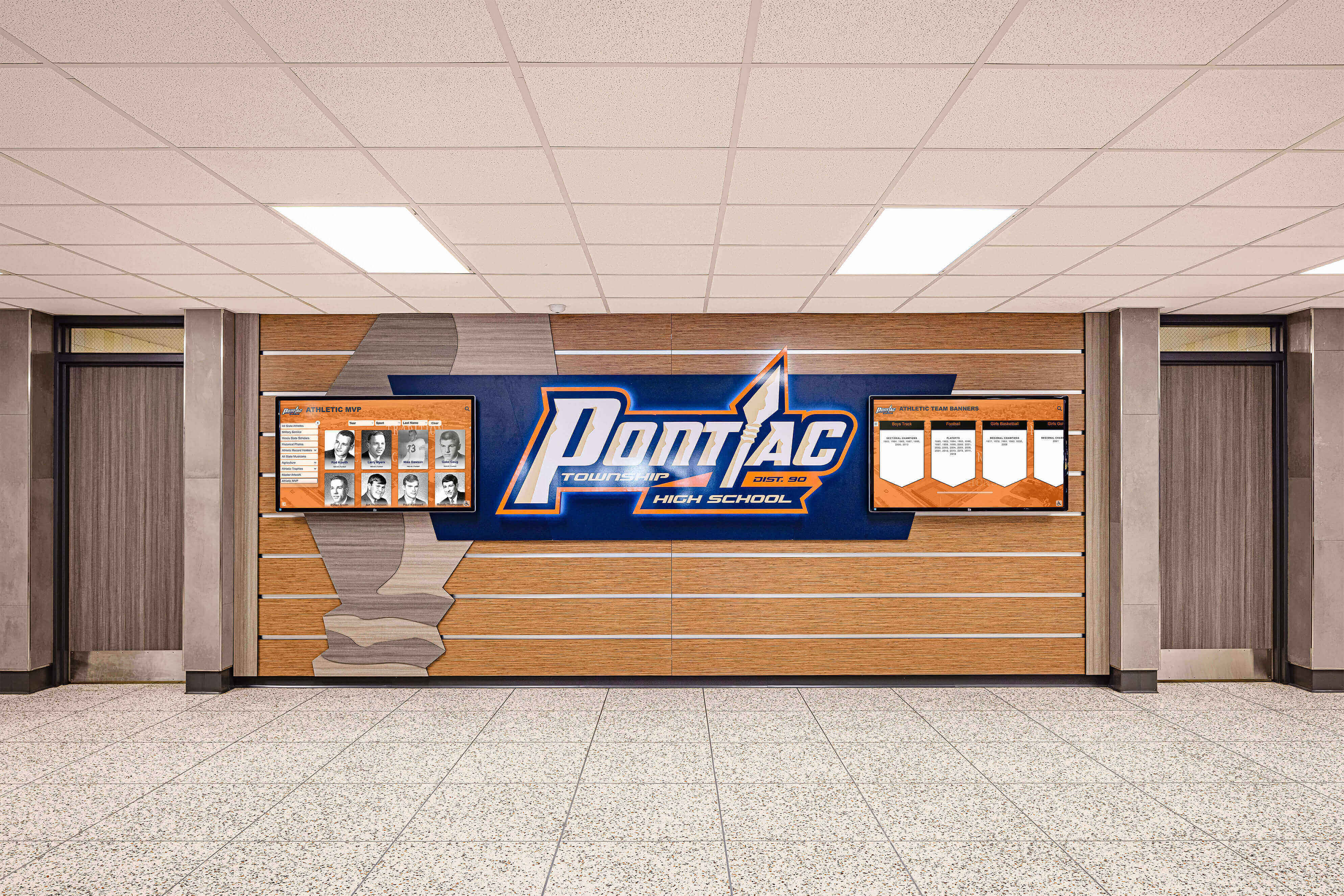 Pontiac high school hallway with dedicated athletic honor wall and logo displays